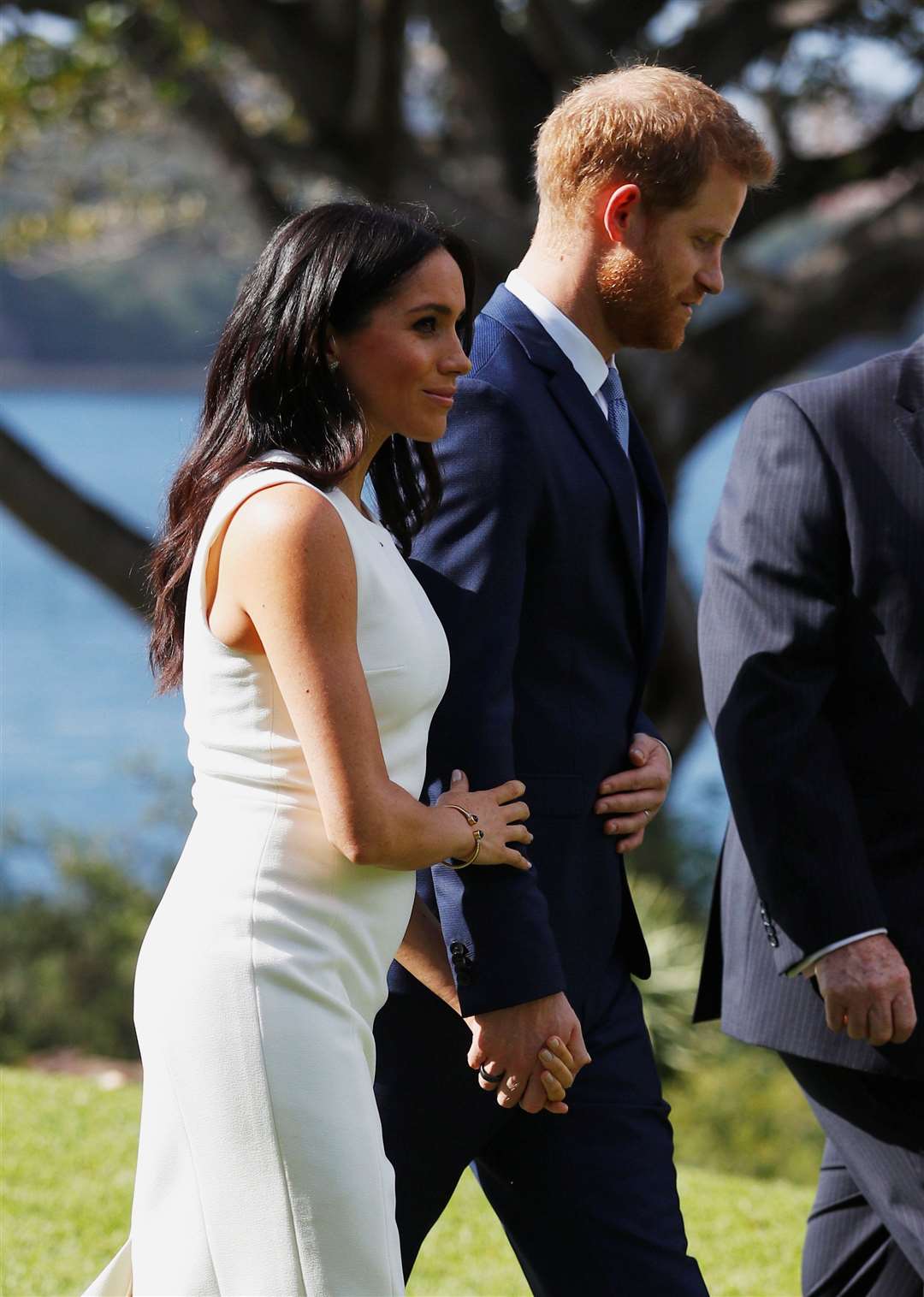 Meghan, with a tiny bump, in Sydney on the first day of their tour to Australia (Phil Noble/PA)