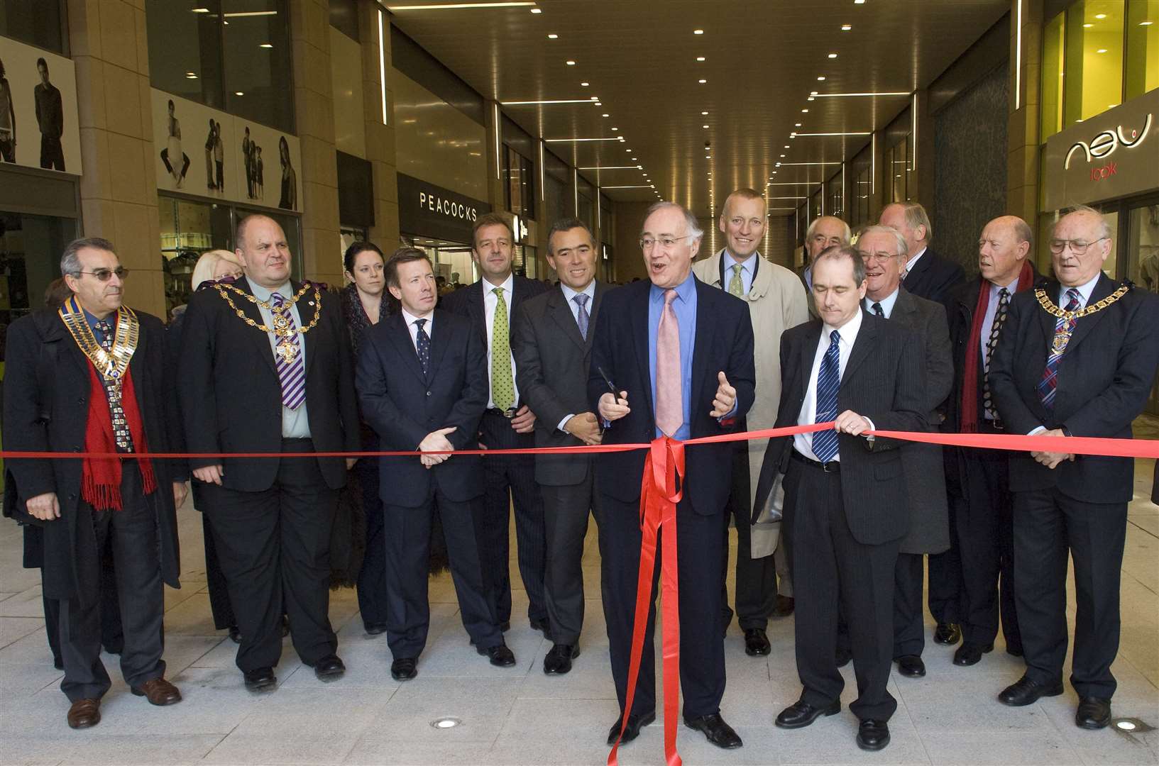 Former Folkestone MP Micheal Howard cuts the ribbon with the help of centre manager Paul Stone in November 2007