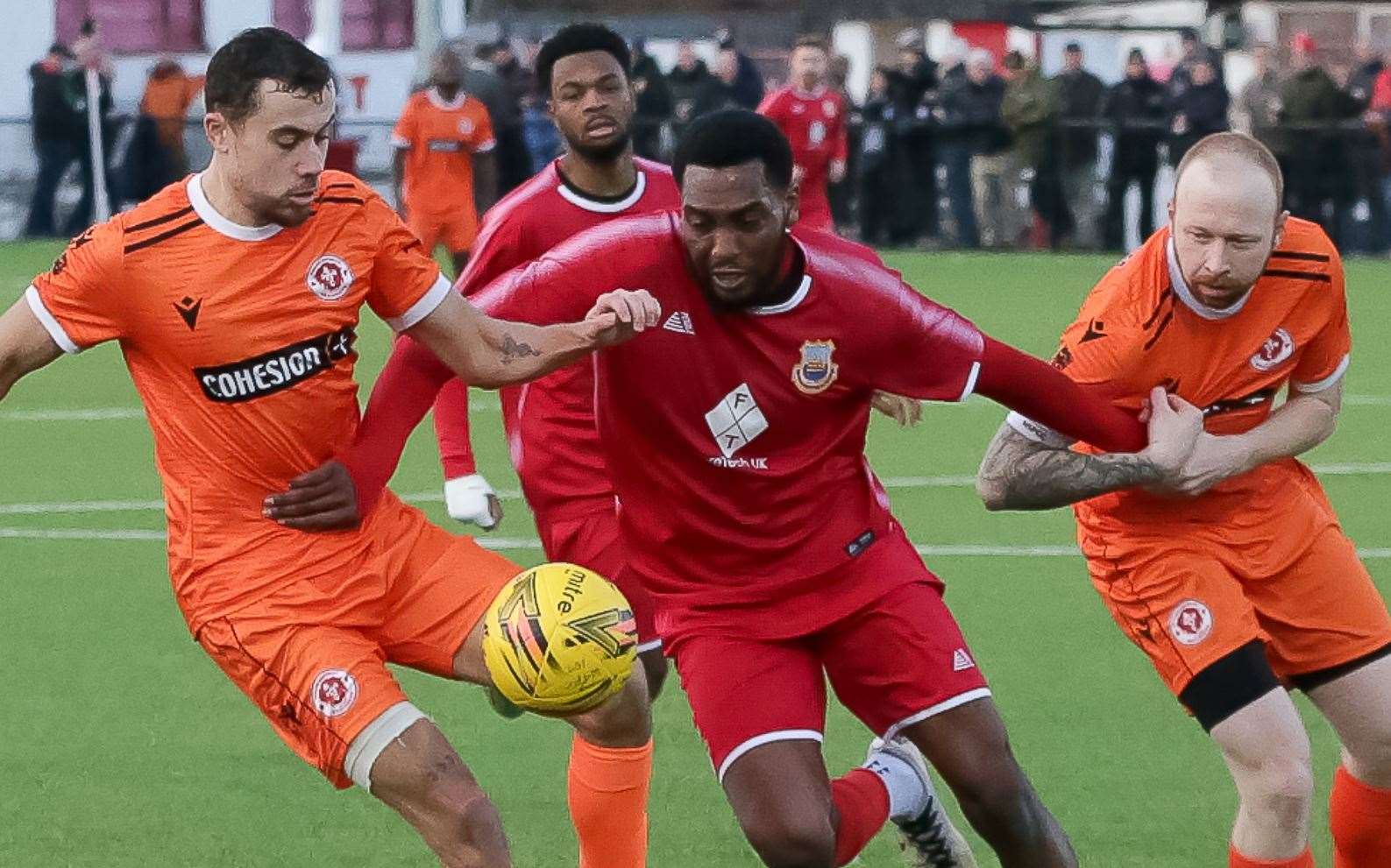 Whitstable scorer Emmanuel Oloyede gets pulled back. Picture: Les Biggs