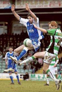 Darren Dennehy battles for the ball with Shaun MacDonald