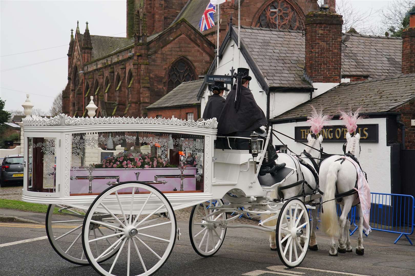 A horse-drawn carriage carrying the coffin of Brianna Ghey arriving for her funeral in Warrington, Cheshire (Peter Byrne/PA)