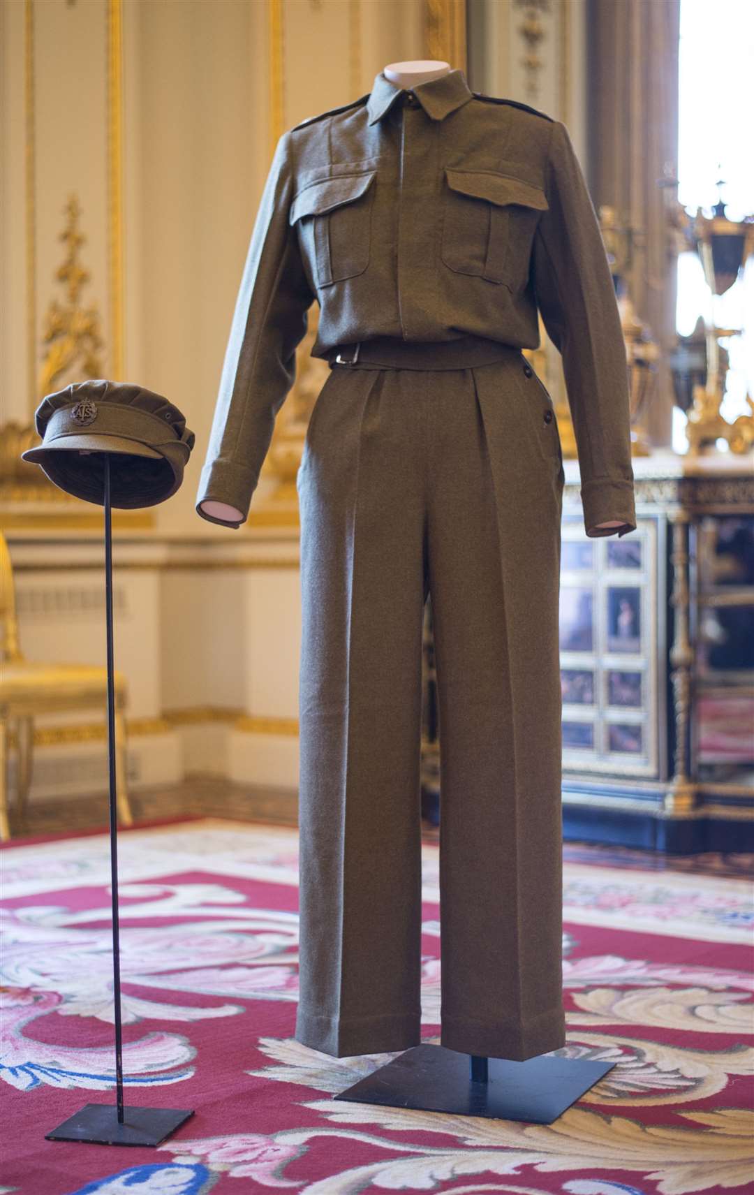 A pair of Auxiliary Territorial Service overalls and a cap, worn by Princess Elizabeth whilst serving in the wartime ATS, on display at Buckingham Palace in 2016 (Lauren Hurley/PA)