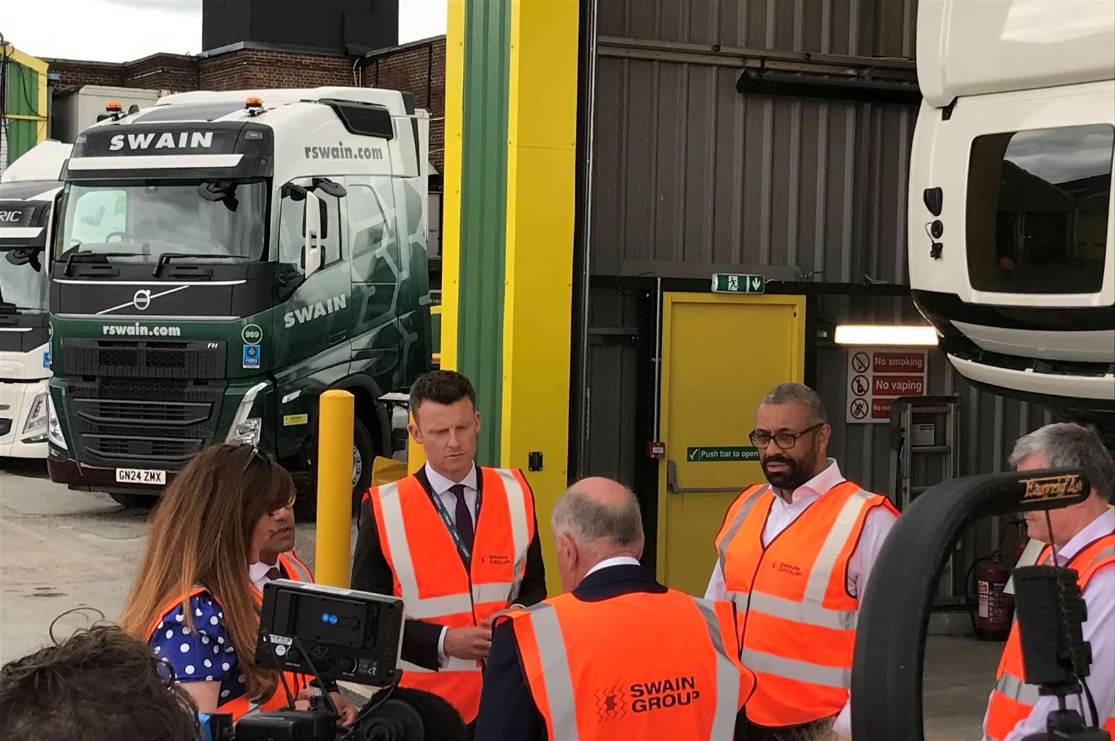 James Cleverly speaking with workers and management at Swain Group in Strood, Rochester, along with Tory parliamentary candidates Kelly Tolhurst, Rehman Chishti, and Nathan Gamester.