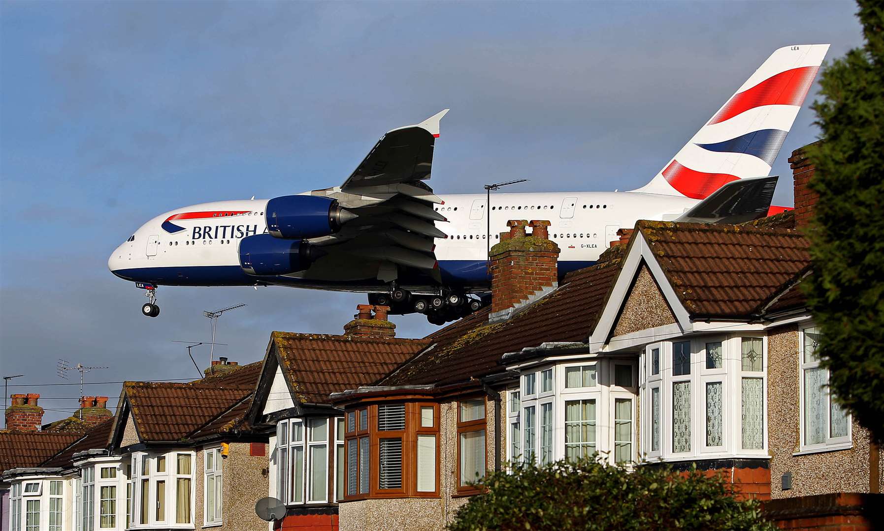 A British Airways Airbus A380 plane lands over houses in Myrtle Avenue during busier times (Steve Parsons/PA)