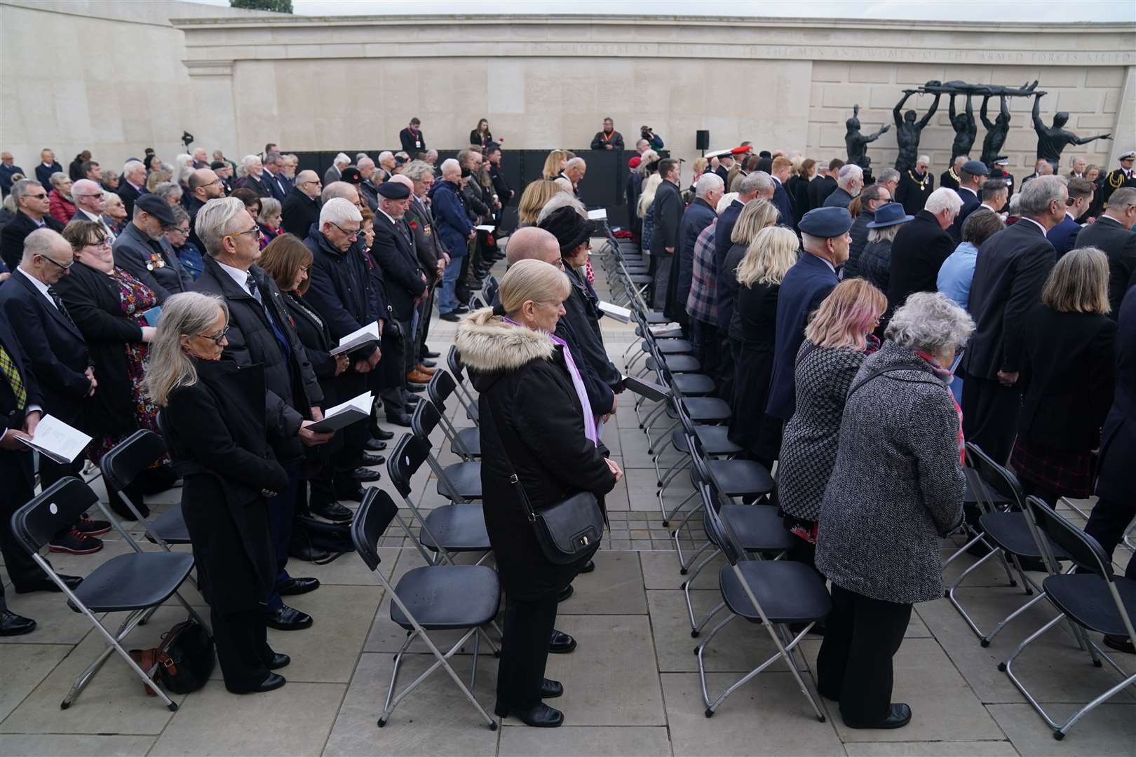 Members of the armed forces, veterans and the public observe a two-minute silence at the National Memorial Arboretum Armistice Day service (Jacob King/PA)