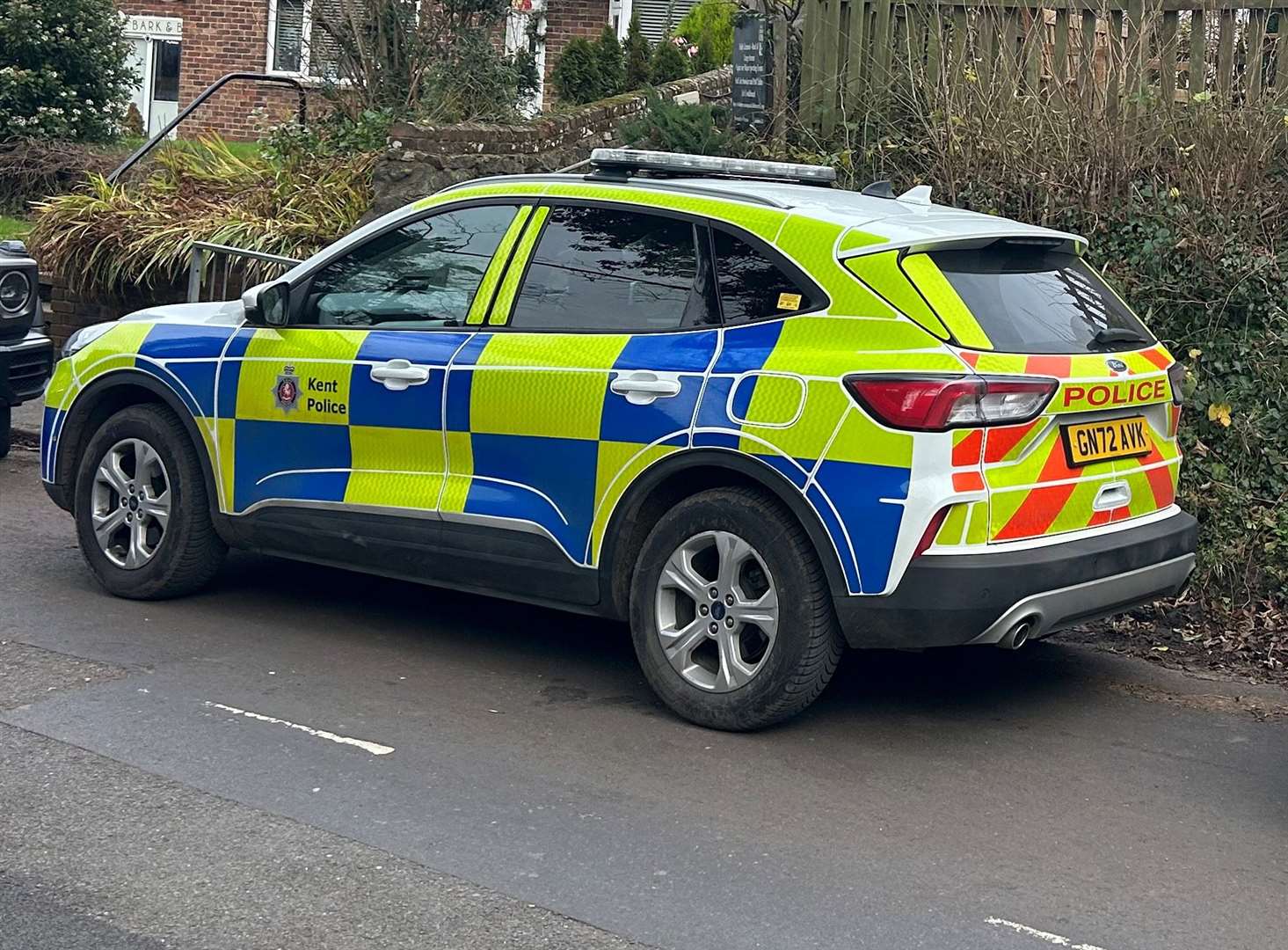 Police were pictured in School Road, Saltwood, near Hythe, today