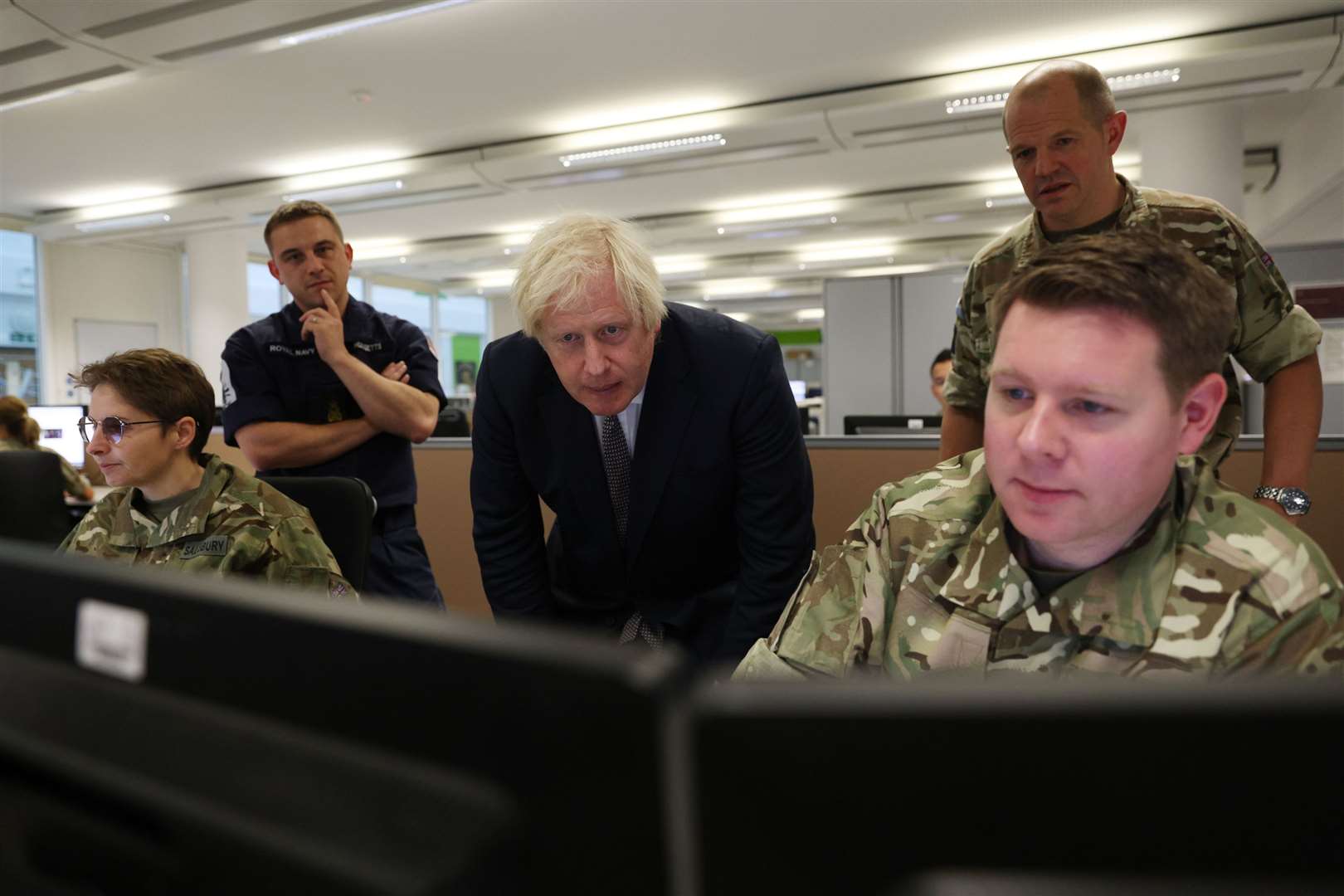 Prime Minister Boris Johnson observes the operations room for the Afghan Relocation and Assistance Policy during a visit to Northwood Headquarters, the British Armed Forces Permanent Joint Headquarters, in Eastbury, north-west London, where he met with personnel working on the UK operation in Afghanistan (Adrian Dennis/PA)