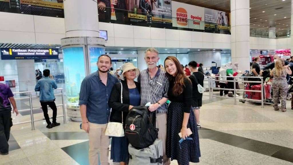 Jim Fitton (second right) with his son Joshua (left), wife Sarijah (second left) and daughter Leila at Kuala Lumpur International Airport (Family handout/PA)