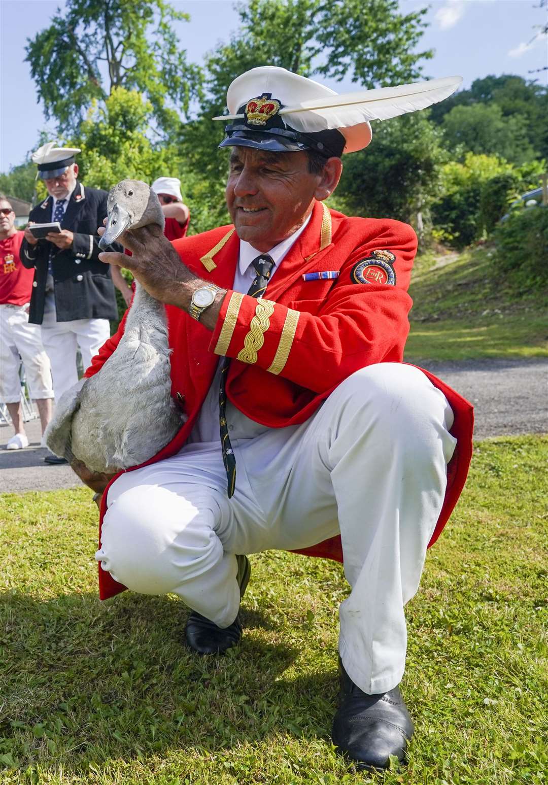 David Barber inspects a swan (Steve Parsons/PA)