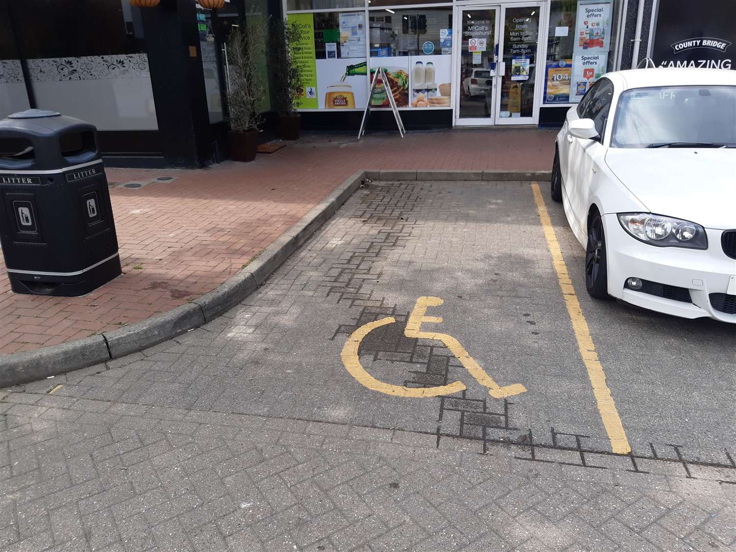 The disabled parking bay is narrower than the adjacent regular space