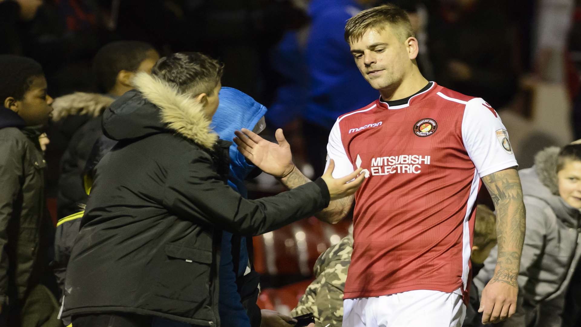 Sam Magri enjoys the three points with a fan after the final whistle Picture: Andy Payton