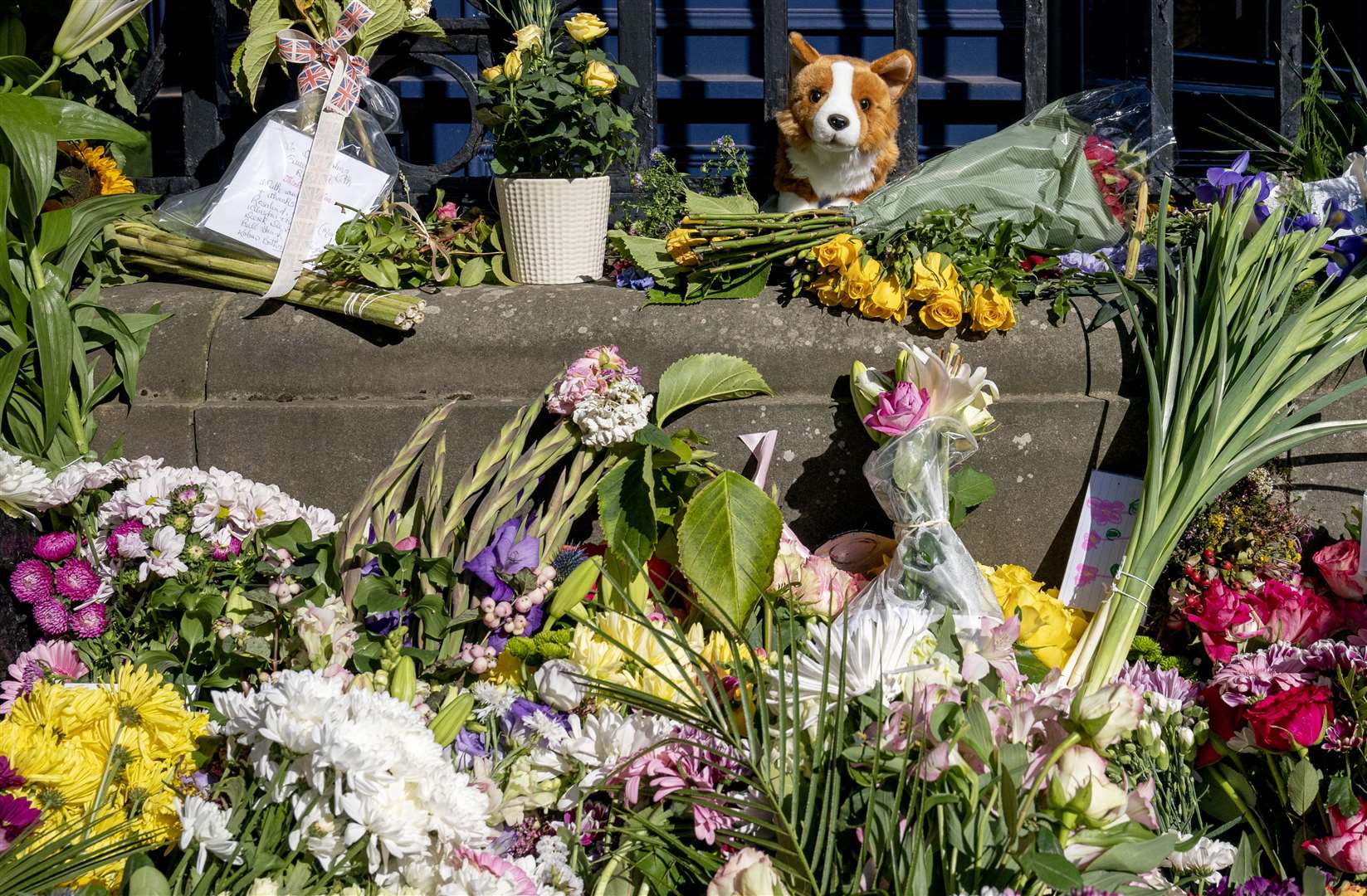 Floral tributes and messages left by the public at the Palace of Holyroodhouse, Edinburgh, following the death of Queen Elizabeth II on Thursday (Jane Barlow/PA)