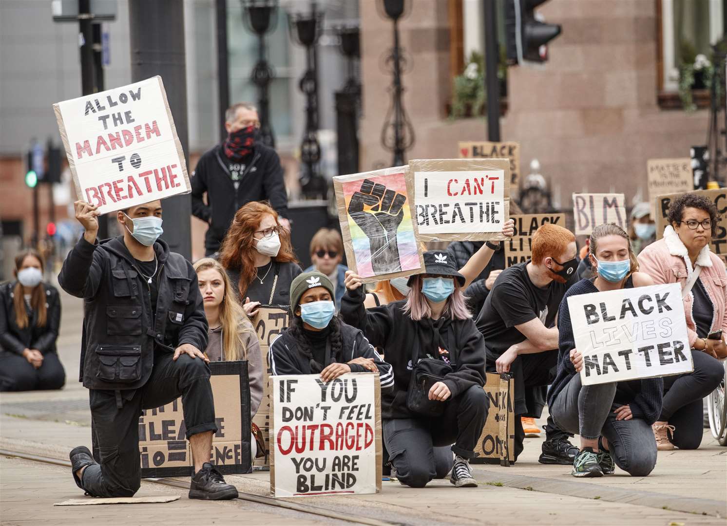 People take a knee during a Black Lives Matter protest rally in Manchester, in memory of George Floyd who was killed on May 25 while in police custody in the US city of Minneapolis.