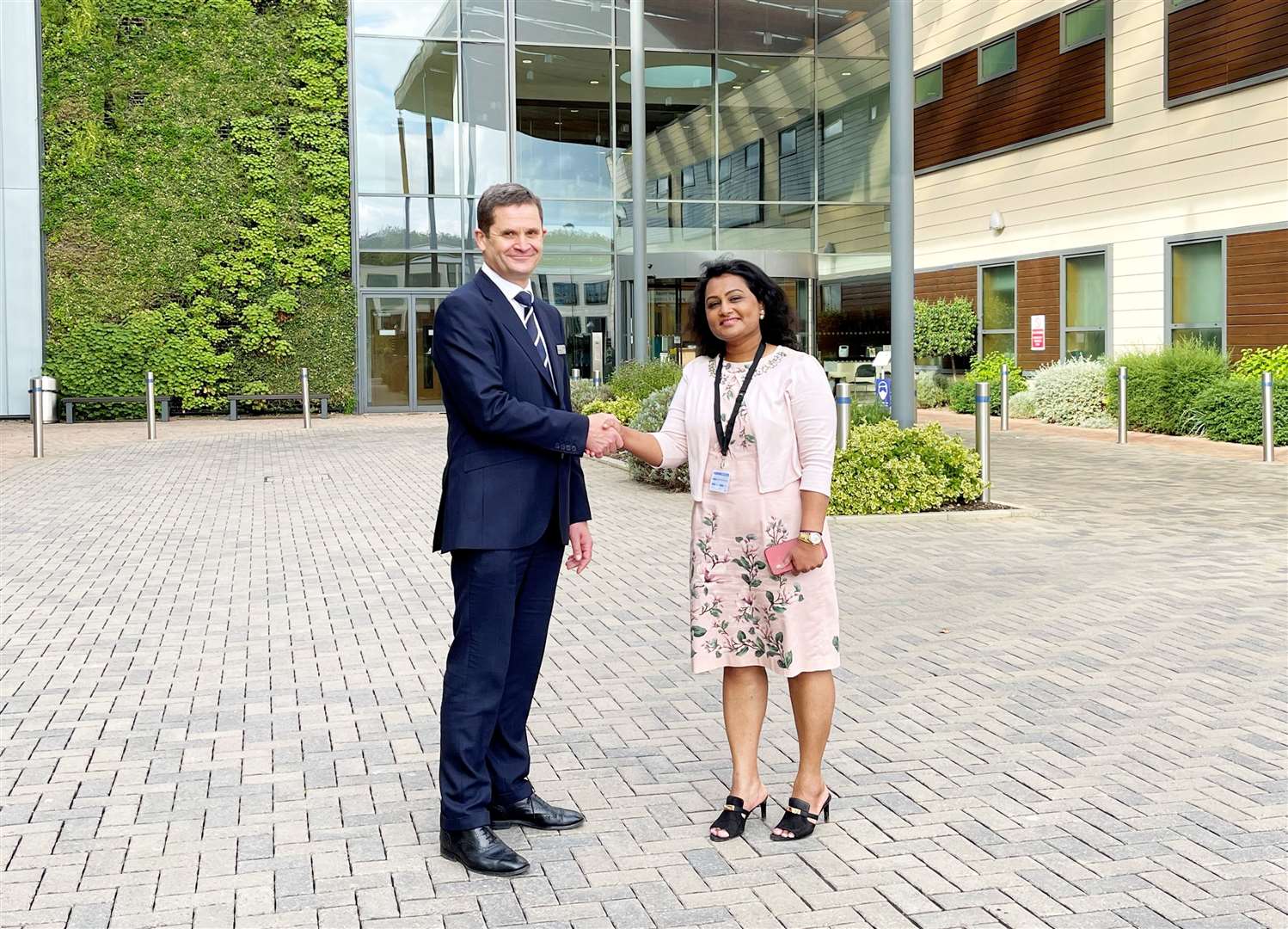 KIMS CEO Simon James shakes on the deal with LycaHealth chair Prema Subaskaran