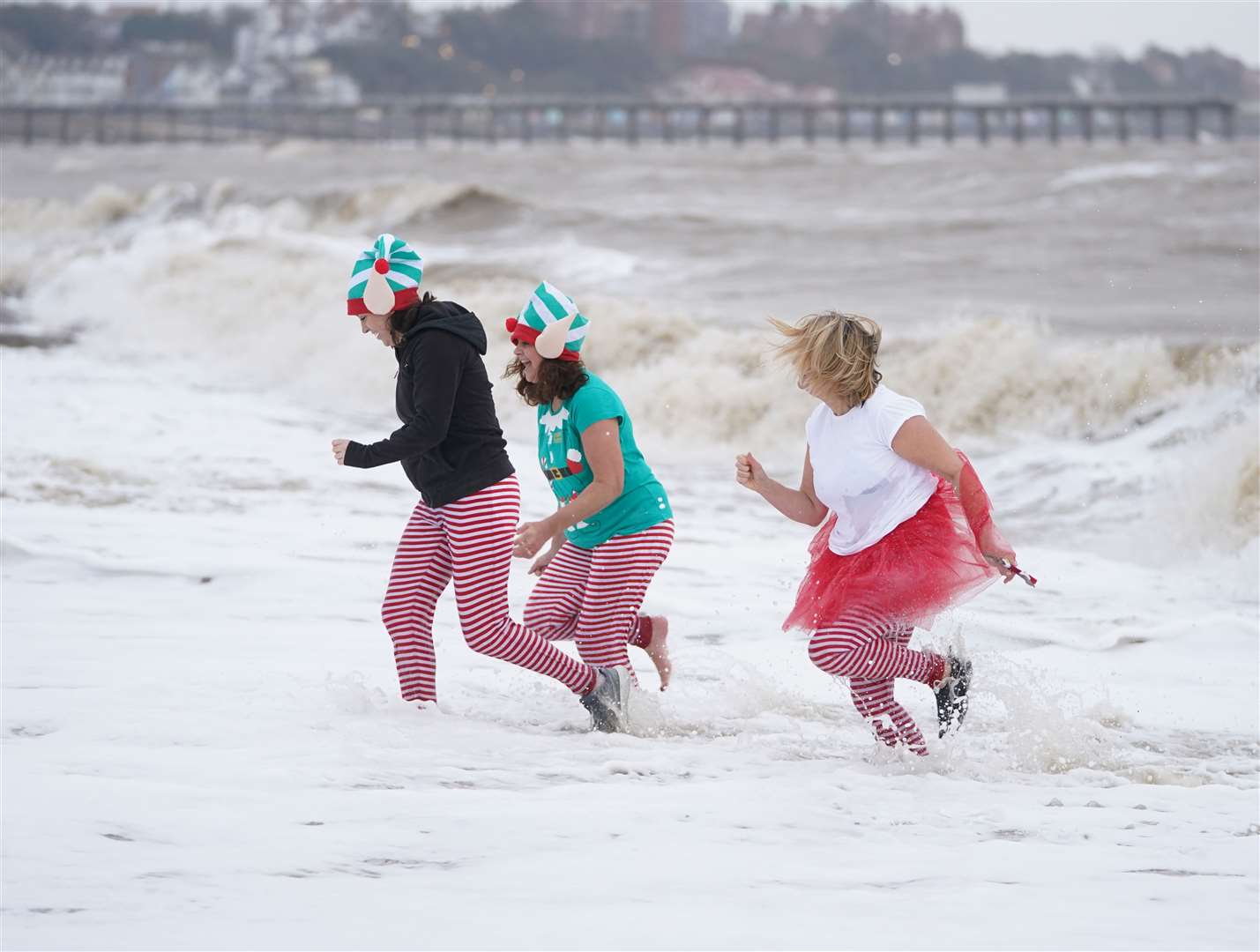 Swimmers in fancy dress run into the sea at Felixstowe (Joe Giddens/PA)