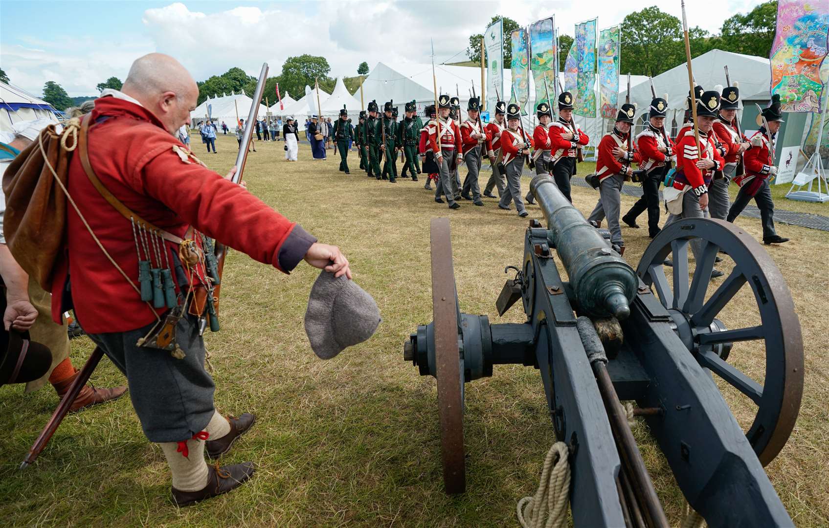 A member of the Devereaux’s Regiment (left) salutes (Andrew Matthews/PA)