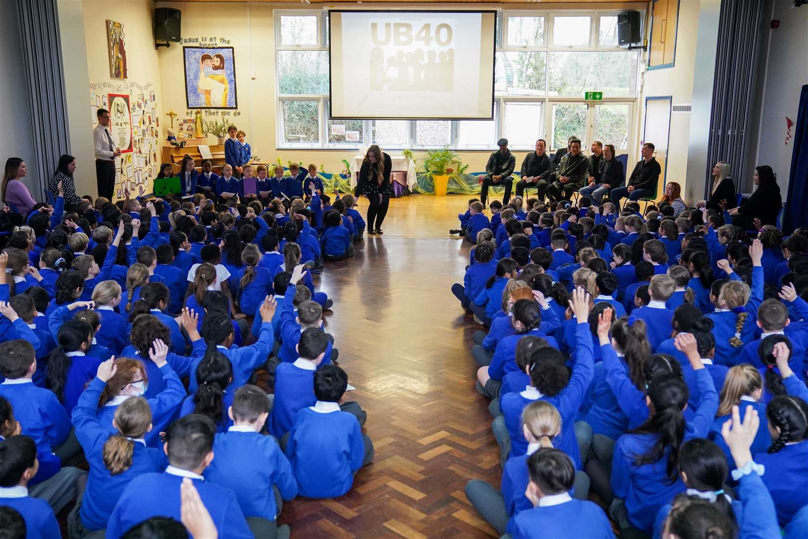 Pupils at St Edward’s Catholic Primary School in Birmingham held a special assembly for members of UB40 (Jacob King/PA)