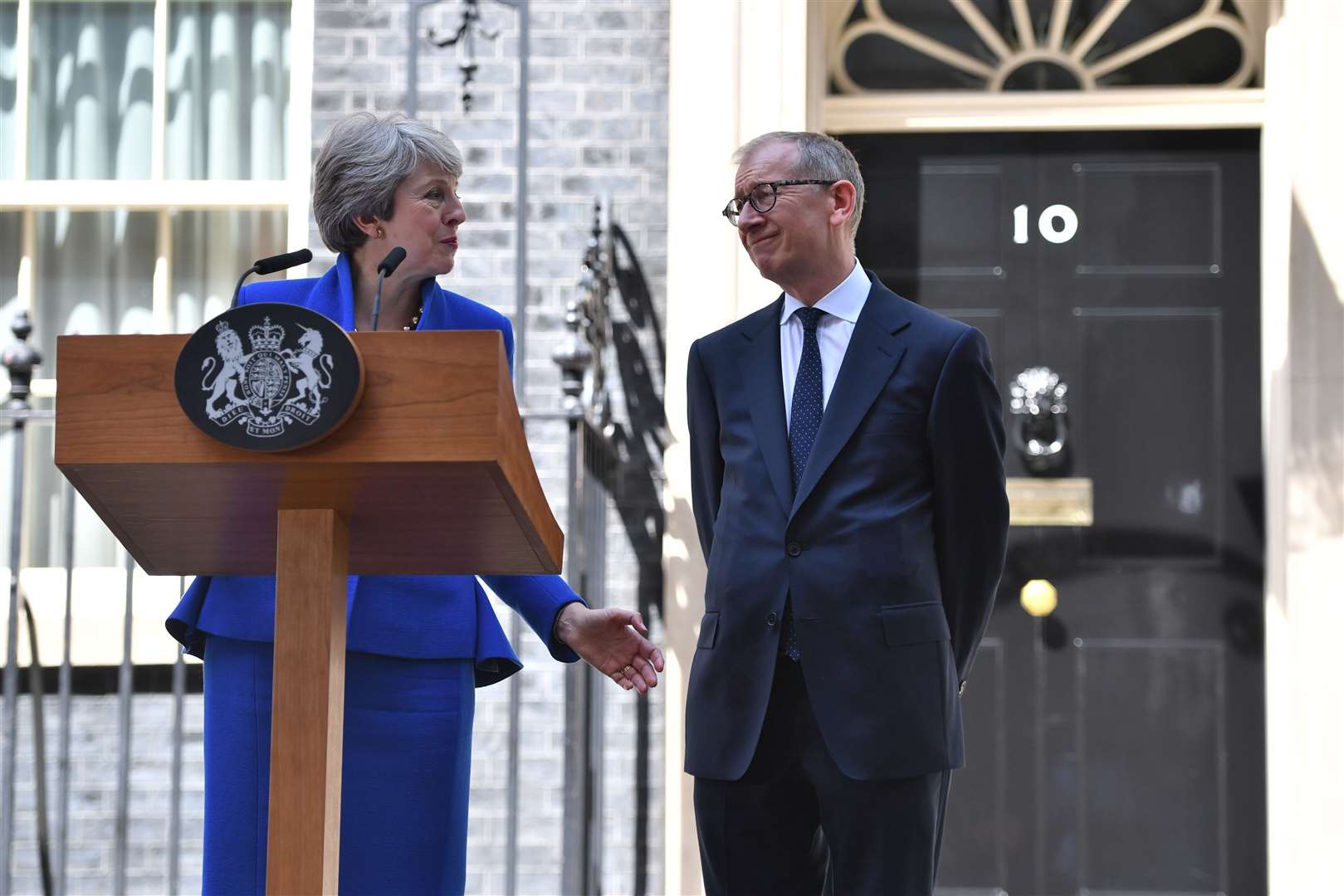 Former prime minister Theresa May announcing her resignation alongside her husband Philip May (Dominic Lipinski/PA)