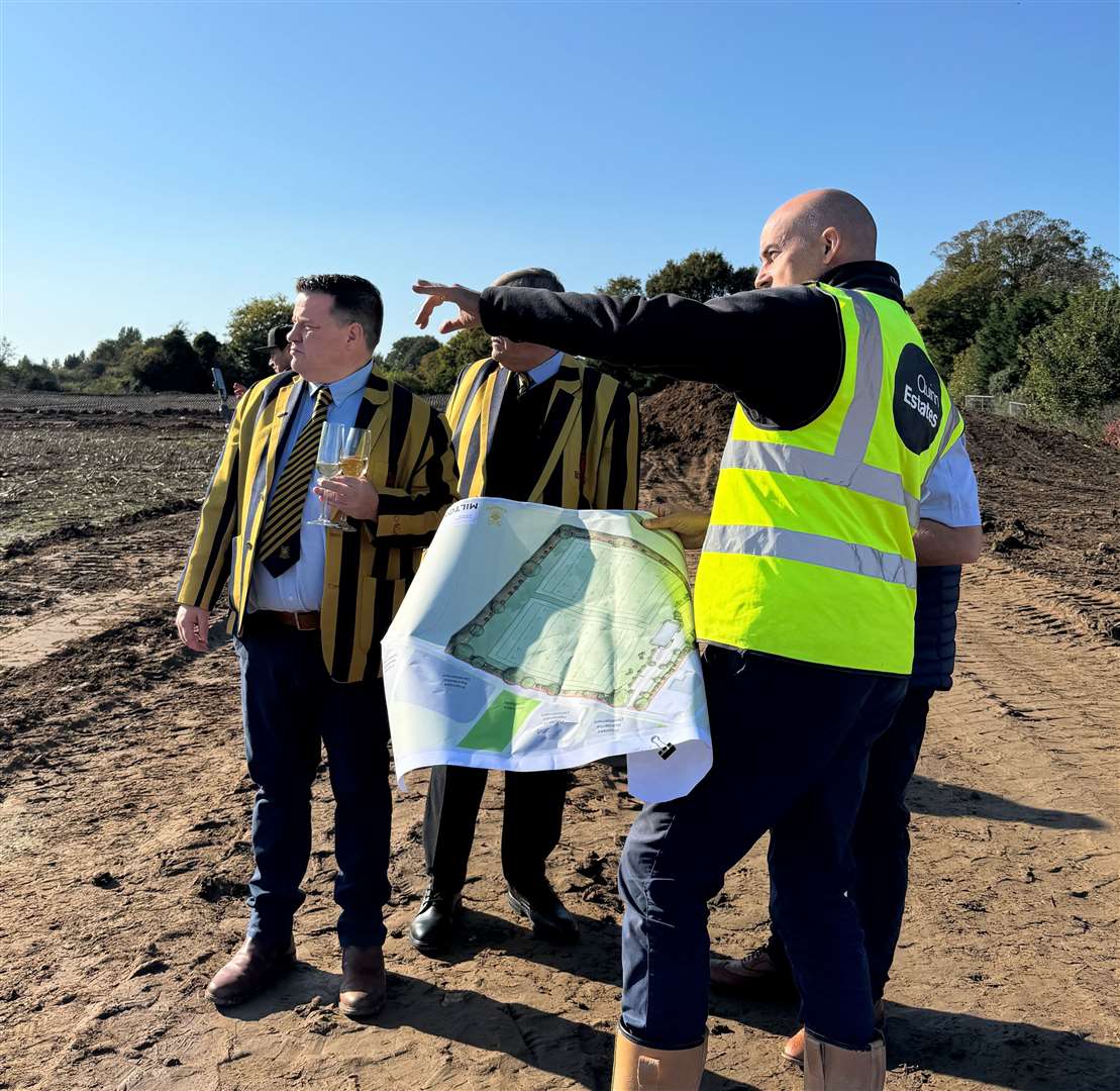 A Quinn Estates builder shows Sittingbourne Rugby Club members how the site will look. Picture: Quinn Estates