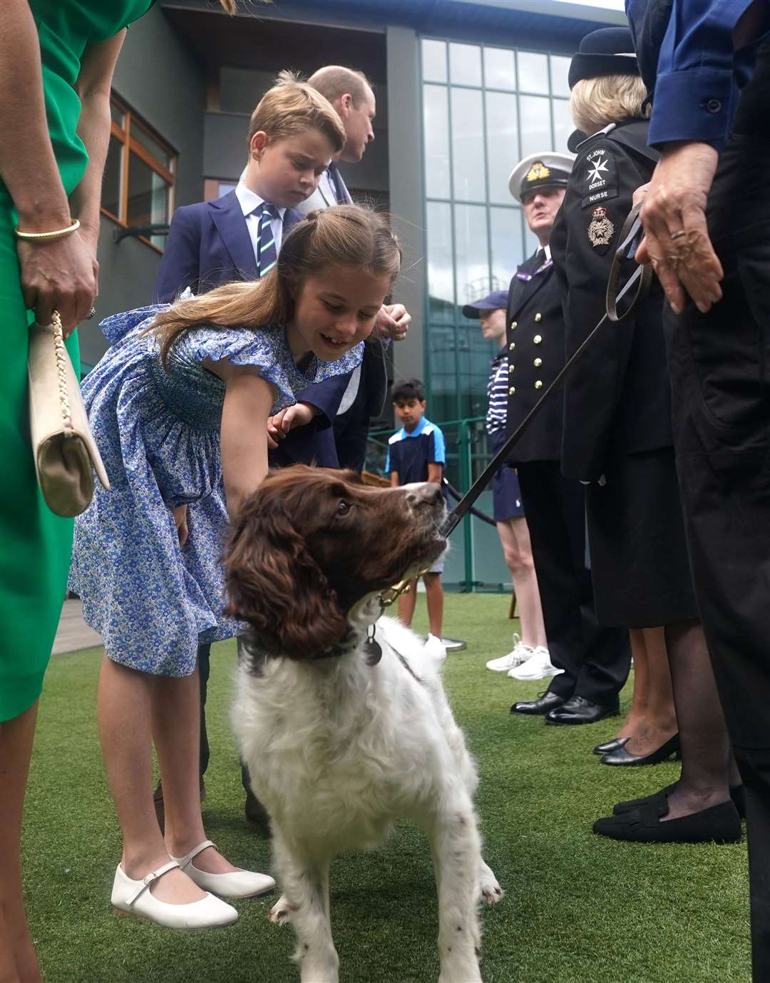 Princess Charlotte petting police dog Stella (Victoria Jones/PA)