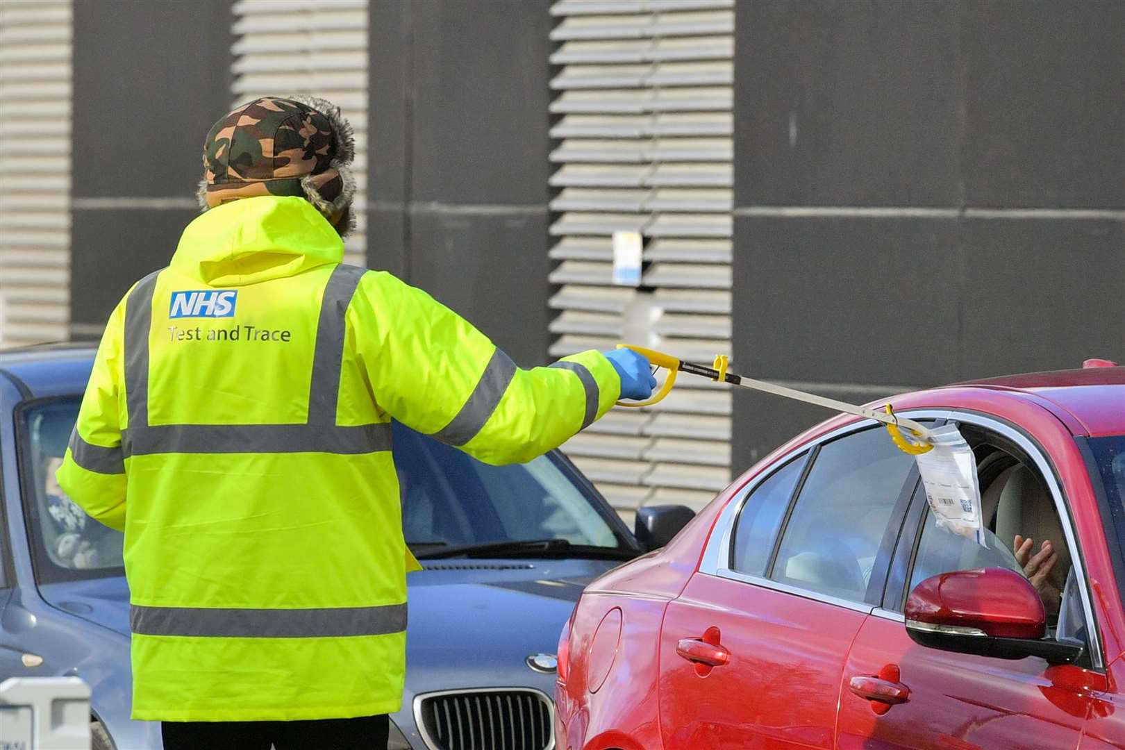 A member of testing staff retrieves a completed kit (Ben Birchall/PA)