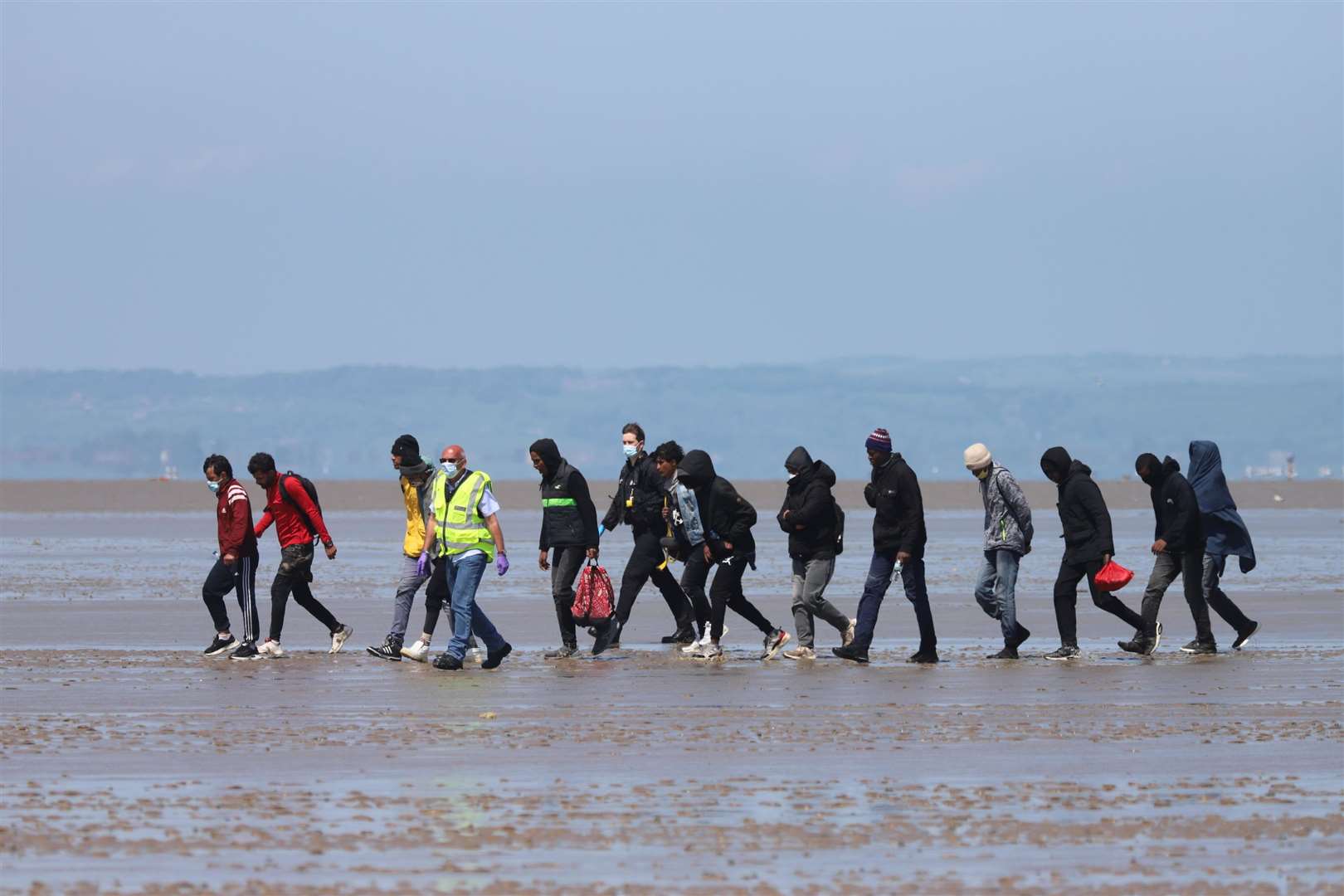 Asylum seekers with two officials at Romney Marsh. Library picture, submitted