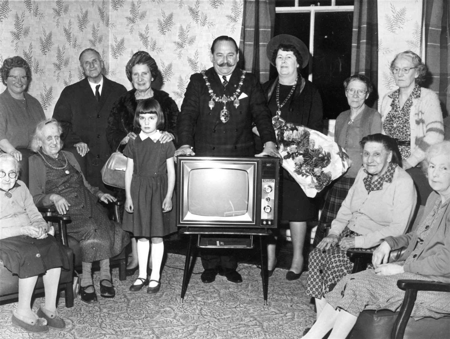 The Mayor of Rochester, Councillor Stuart Fry, hands over a television on behalf of the Keg Megs club at an old people's home in Balfour Road, Chatham, in 1965