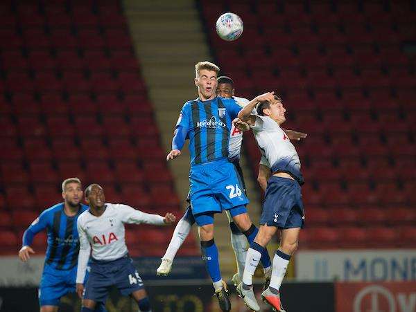 Gillingham's Kack Tucker jumps for the ball Picture: Ady Kerry (4704999)