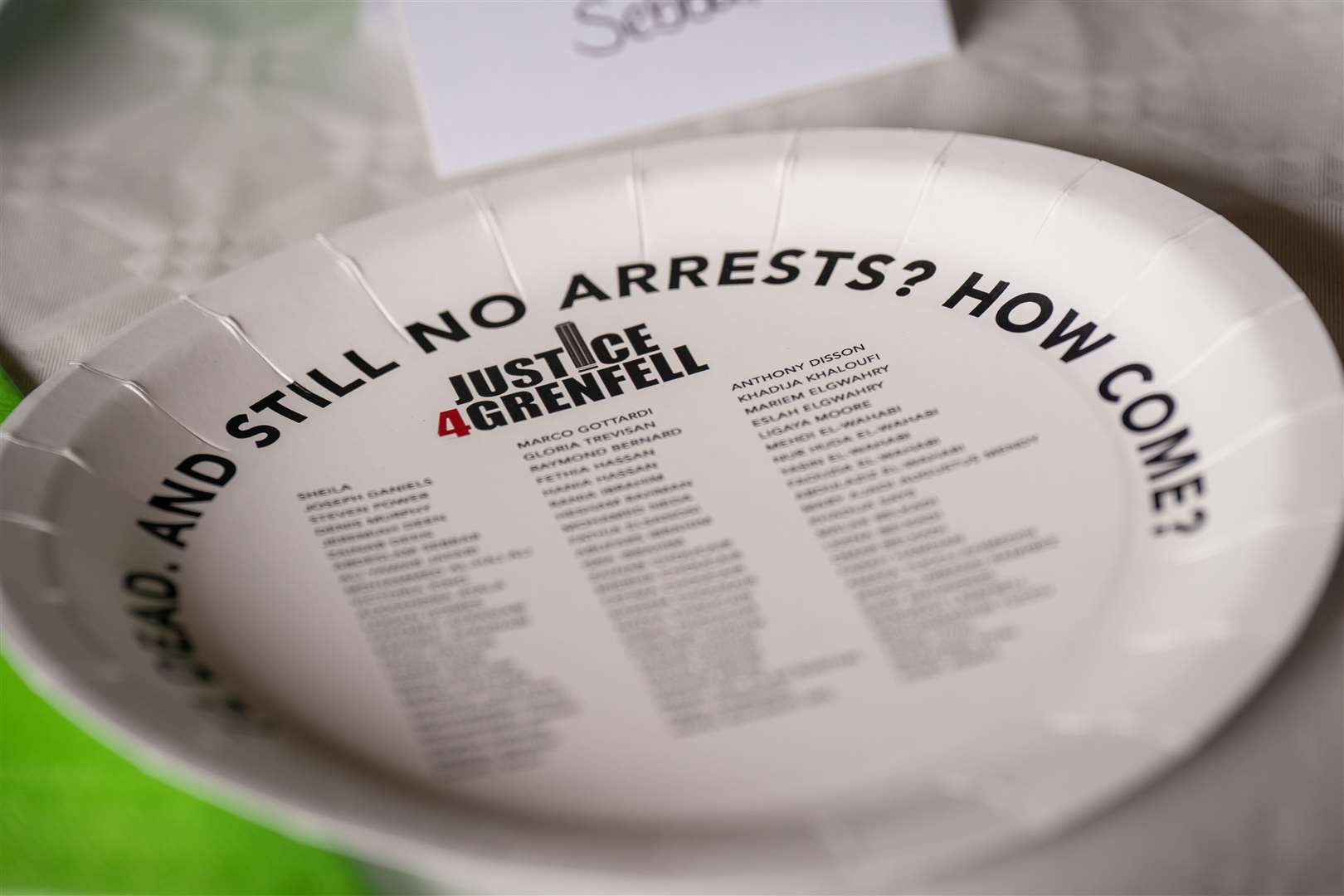 A dinner plate laid on a table for 72 absent people (Aaron Chown/PA)