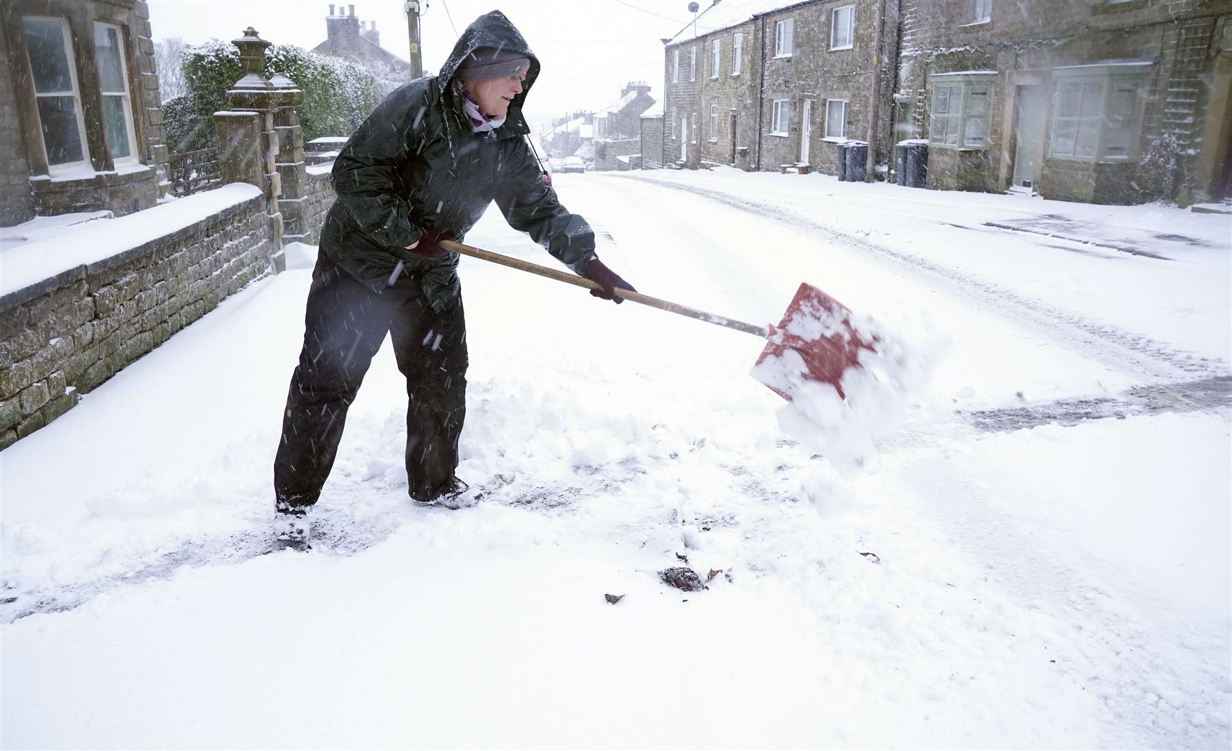 The snow meant hard work clearing a path for some (Owen Humphreys/PA)