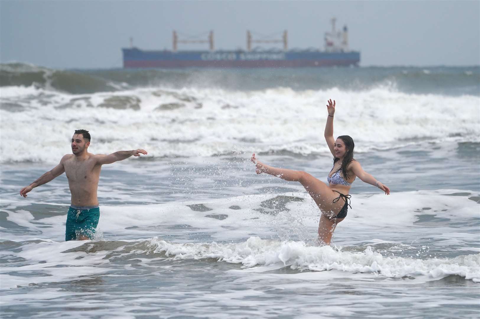 Ollie King, 22, and his sister Laura, 19, take a dip into the sea at King Edward’s Bay in Tynemouth (Owen Humphreys/PA)