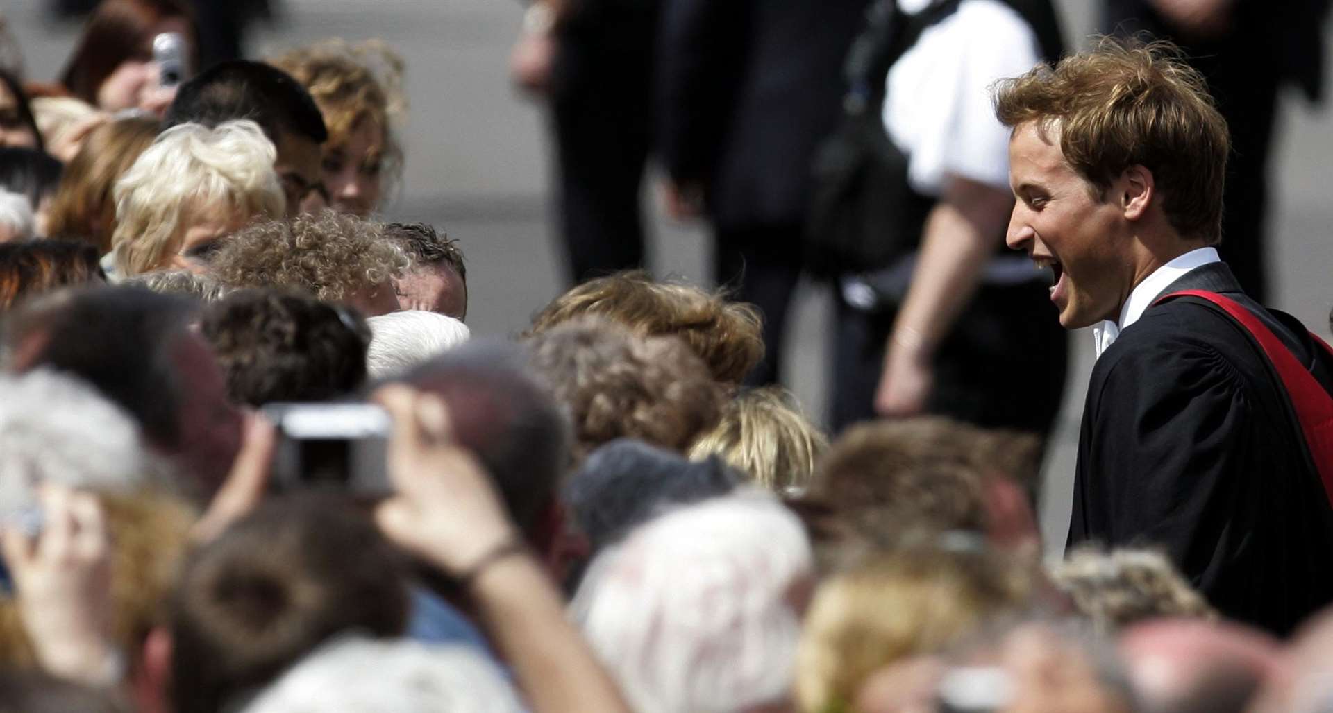 William meets the crowds as he leaves the St Salvator’s Quadrangle as he graduated in geography (David Cheskin/PA)