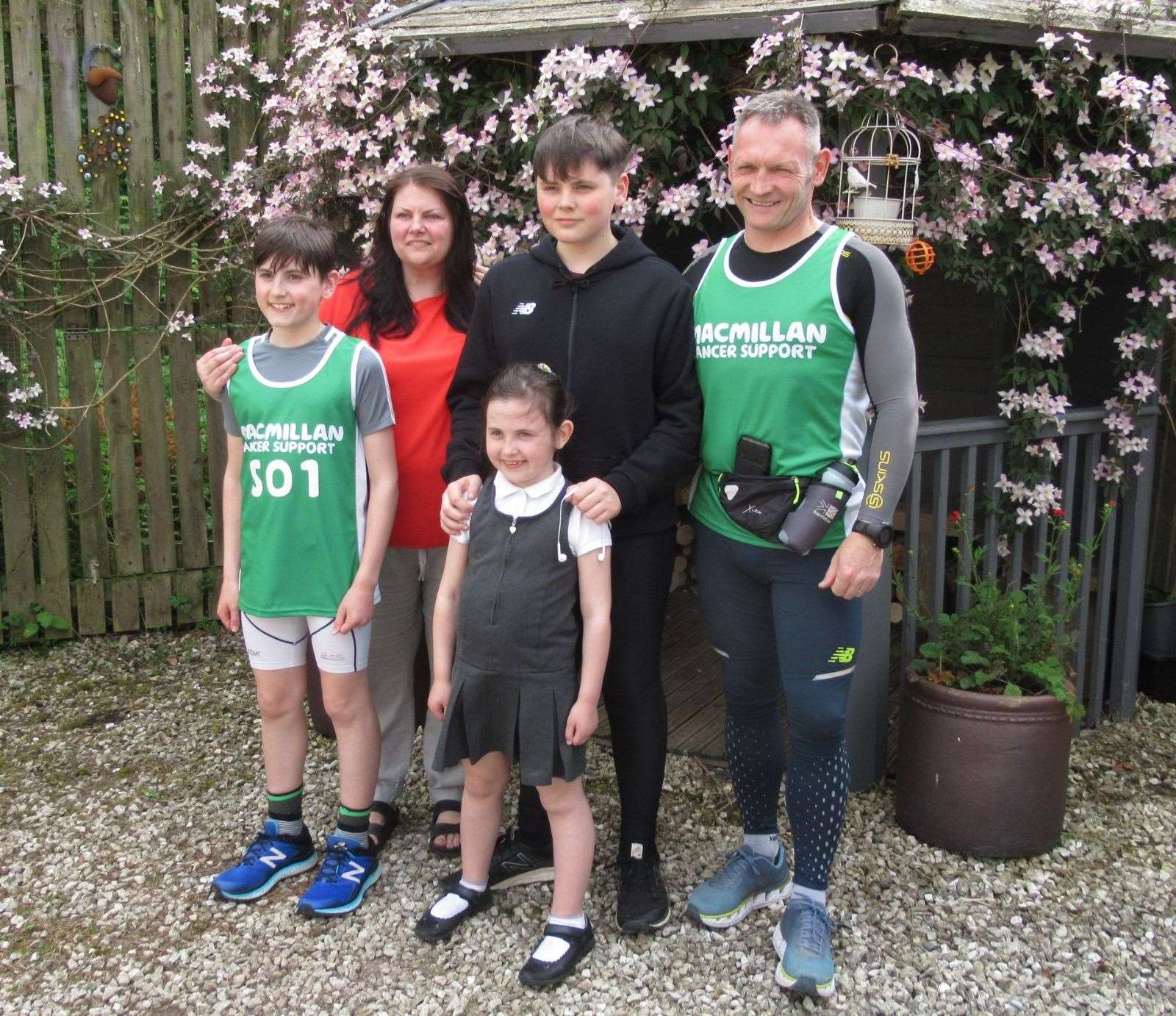 Gary McKee, right, with wife Susan and children Alfie, Beau and Minnie (PA)