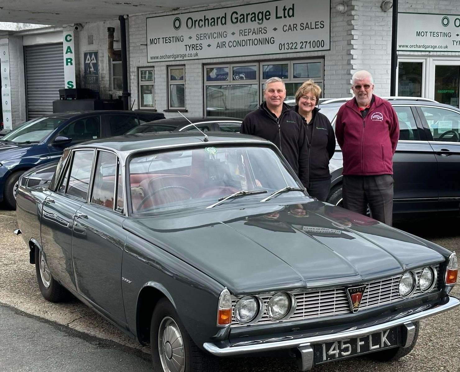 Paul Smith, right, with his Rover P6 and Orchard Garage Limited owners Pam and Geoff Manwaring. Photo credit: Pam Manwaring