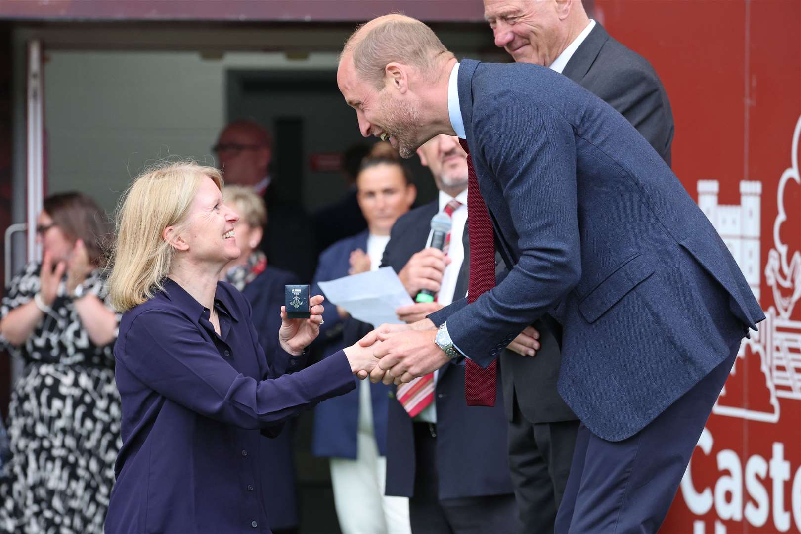 William presents a brooch to a former player from the WRU’s Missing Caps campaign, which aims to recognise players who were historically missed when they played for Wales (Chris Jackson/PA)