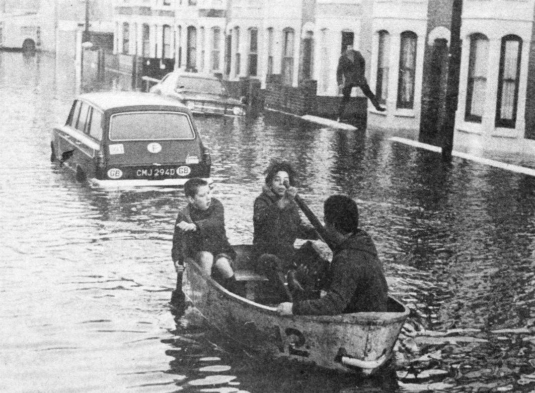 When the car was submerged by water this family in Delamark Road found alternative transport in the form of a dinghy when the sea flooded Sheerness in January 1978. Picture: KM photographer