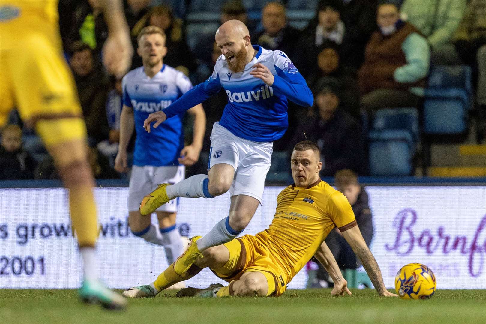 Gillingham midfielder Jonny Williams on the end of a heavy challenge Picture: @Julian_KPI