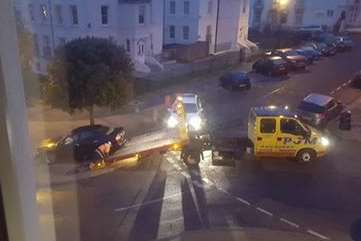 The crashed car is towed away from Lansdowne Square