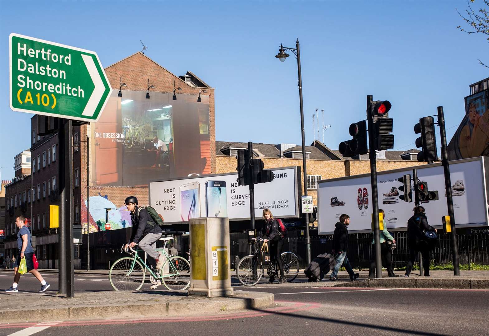 A sign for Dalston as cyclists crossing the road at a busy crossroad near Hoxton Square, Shoreditch, home of a big hipster community. Picture: iStock / Drimafilm