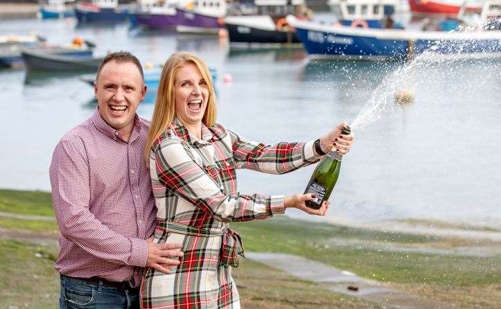 Luke and Alison crack open the Champagne after winning £1 million. Picture: Allwyn