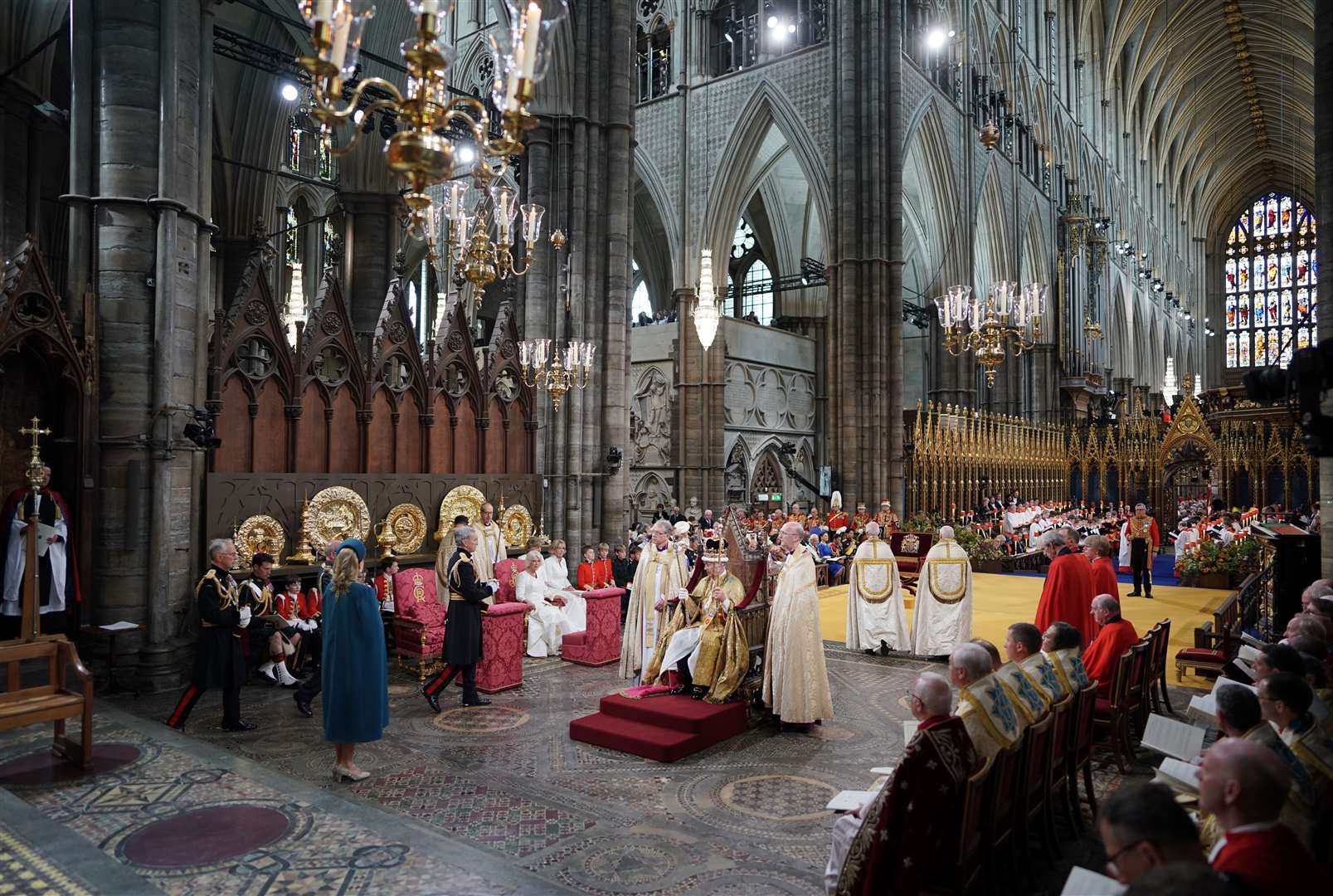 King Charles in the Coronation Chair, wearing St Edward’s Crown and holding The Sovereign’s Sceptre with the Dove, in his left hand, and The Sovereign’s Sceptre with Cross, in his right, during his coronation ceremony in Westminster Abbey (Jonathan Brady/PA)