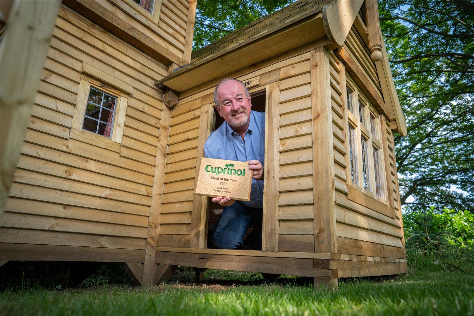 Lockdown category winner Mark Campbell with his castle-inspired shed (Cuprinol Shed of the Year/PA)