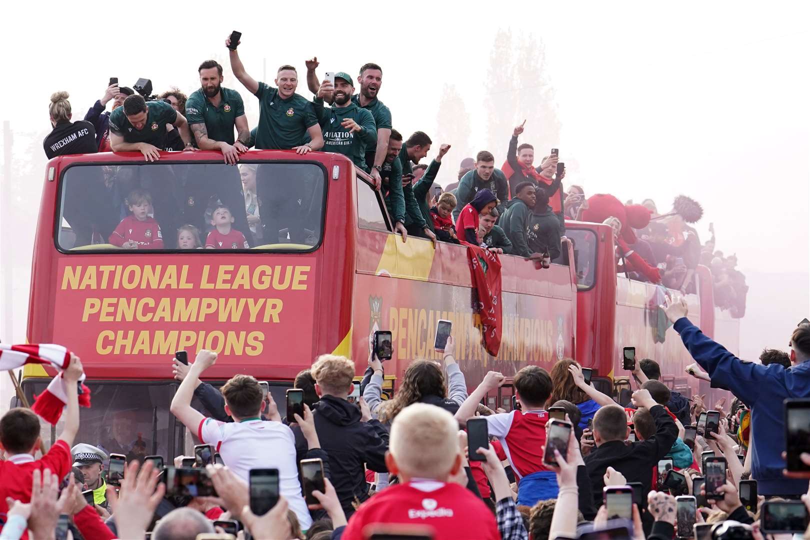 Fans celebrate with players in Wrexham (Martin Rickett/PA)