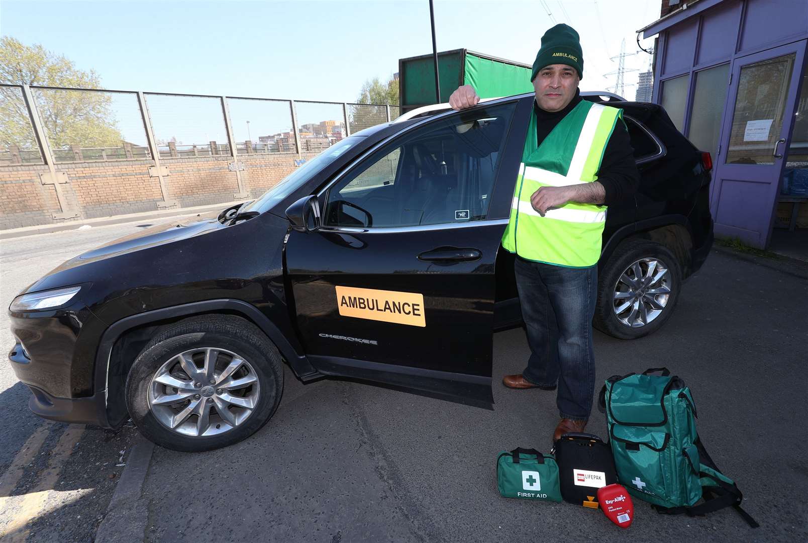 Jonathan Ganesh, president of the Docklands Victims’ Association and an NHS Volunteer Responder, with an ambulance donated by Elite Support Services to support the efforts against the Covid-19 outbreak, in London (Yui Mok/PA)