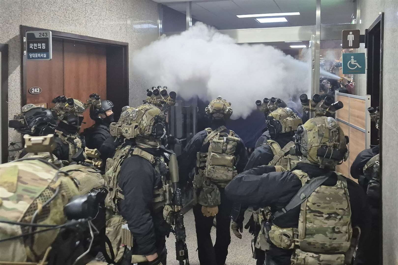 National Assembly employees spray a fire extinguisher towards soldiers at the National Assembly in Seoul, South Korea (Cho Da-un/Yonhap via AP)