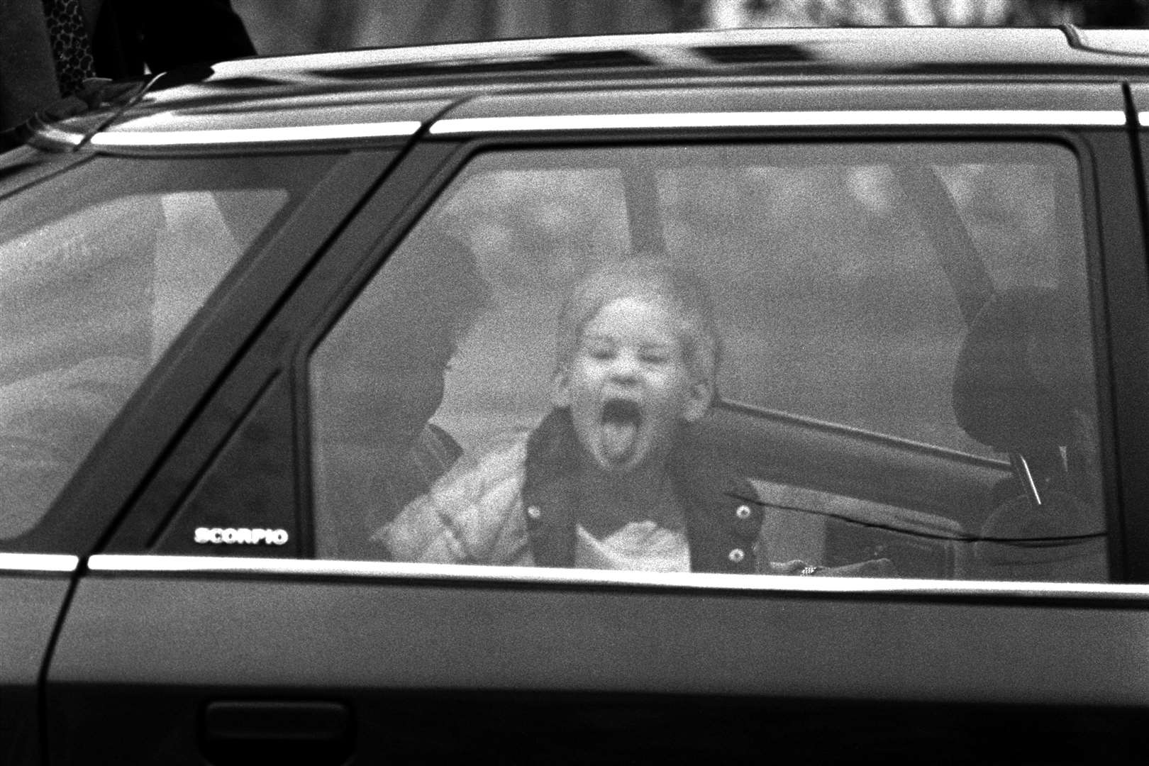 A three-year-old Prince Harry sticks out his tongue at photographers (PA)