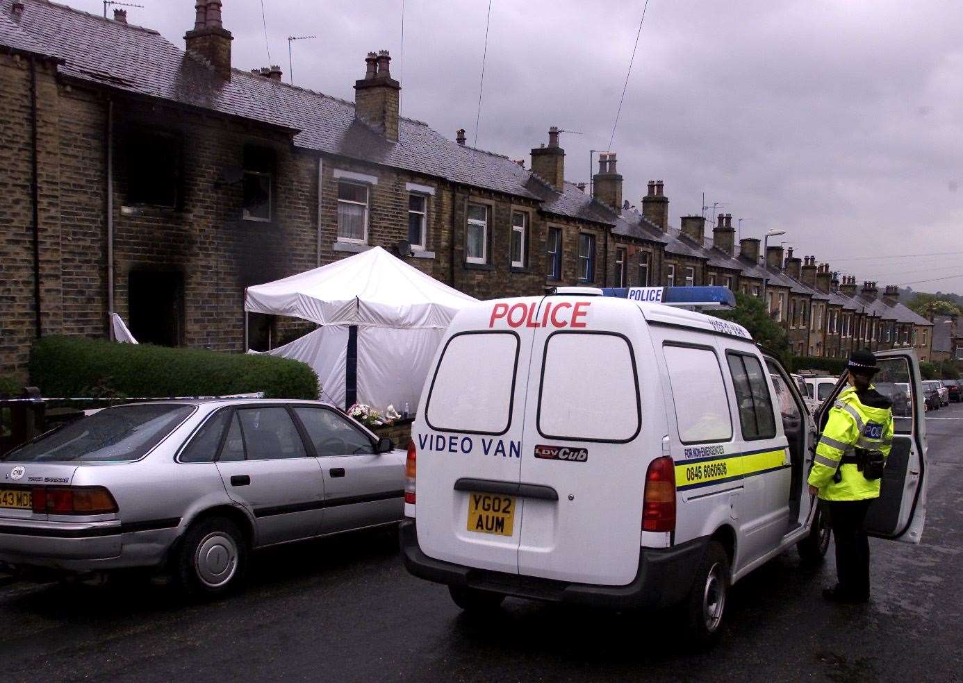 A police officer stands guard outside the house in Osborne Road after the fire (Phil Noble/PA)