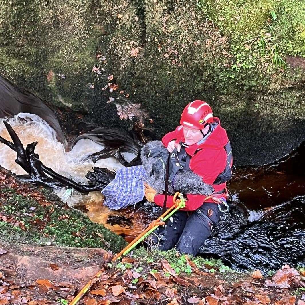 Rescuers pull Margot the dog to safety at the Devil’s Pulpit waterfall (Lomond Mountain Rescue Team/PA)