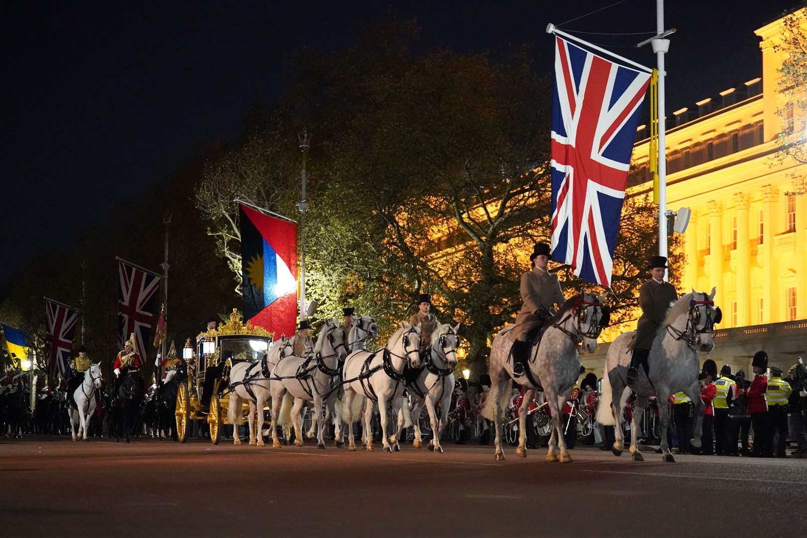 Soldiers dressed in bright yellow and red military uniforms paraded past Buckingham Palace towards Westminster Abbey just after 12.20am on Wednesday (James Manning/PA)