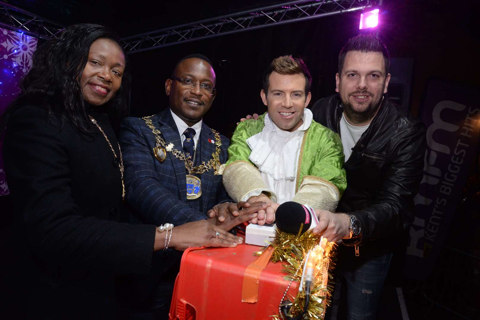 Mayoress Bridget Tejan, Mayor of Medway Cllr Habib Tejan panto star Derek Moran and KMFM's Rob Wills at the Rochester Christmas Lights switch-on during Saturday evening. Picture: Chris Davey. (21787599)